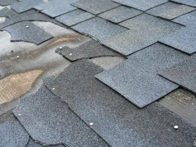 Asphalt shingles with curling edges and surface wear