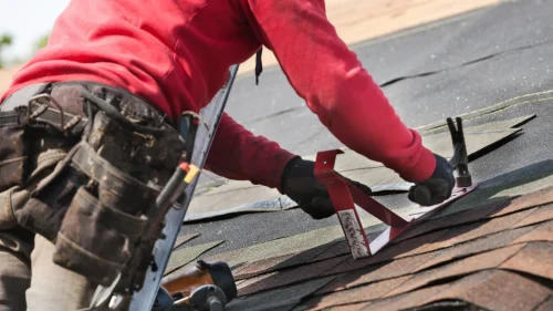 Roofing crew installing shingles on a residential home in Bentonville, Arkansas