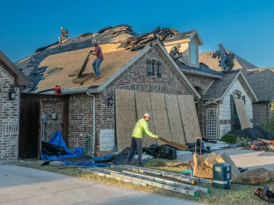 Bentonville homeowners meeting with a roofing contractor to discuss roof replacement