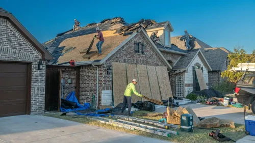 Bentonville homeowners meeting with a roofing contractor to discuss roof replacement