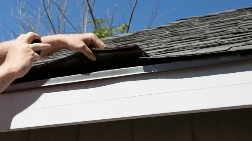 Roofing professional assessing roof damage on a Bentonville home