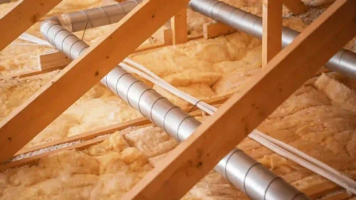 Attic insulation and ventilation ductwork showing components that affect indoor air quality