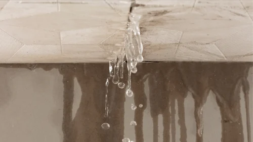 Water leaking through a damaged ceiling during heavy rain in Northwest Arkansas