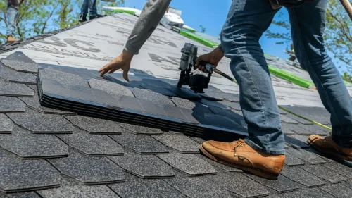 Roofing crew installing a new roof on a home in Fayetteville, Arkansas