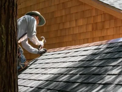 Roofer installing flashing on a roof