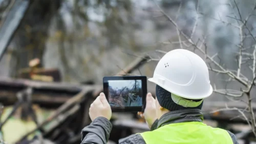 Roofing contractor documenting storm damage for insurance claim