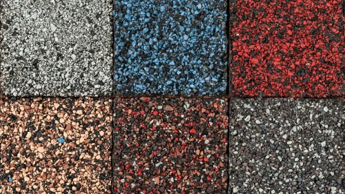 Close-up of asphalt shingles samples on a table during consultation