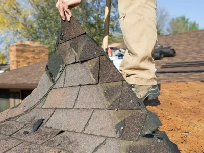Roof with missing shingles exposing the underlayment