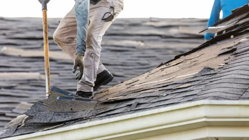 Roofer inspecting a storm-damaged roof in Arkansas