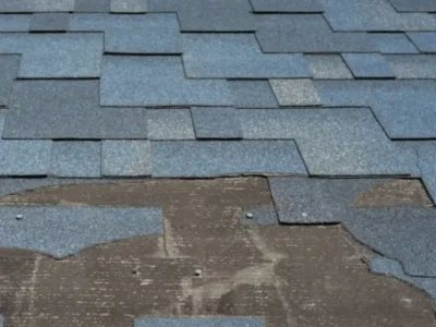 Deteriorating roof shingles showing age and weather damage